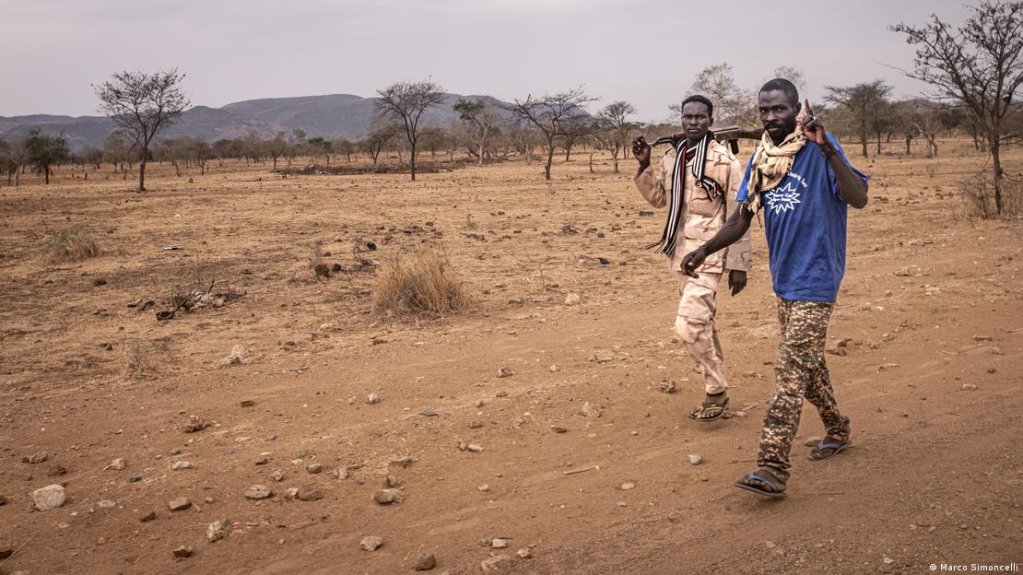 Two RSF fighters walk along a roadside on the outskirts of Kauda in the Nuba Mountains | Photo: Marco Simoncelli