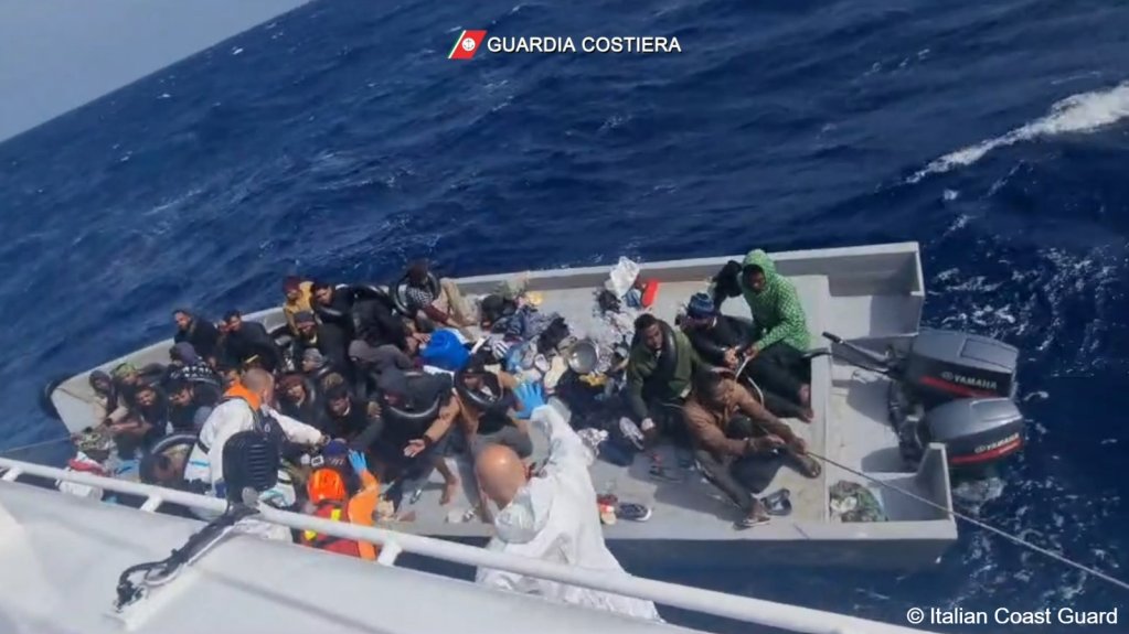 A picture taken from an Italian coast guard vessel shows a rescue operation in progress in the central Mediterranean amid large waves and rough seas | Source: Italian coast guard press release video still www.guardiacostieria.gov.it