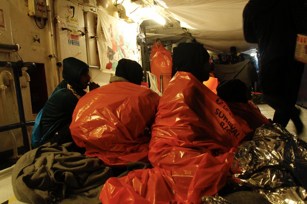 Passengers on the Humanity 1 rescue ship in emergency blankets, following a rescue operation in the Mediterranean sea. | Photo credit: Nicole Thyssen / SOS Humanity