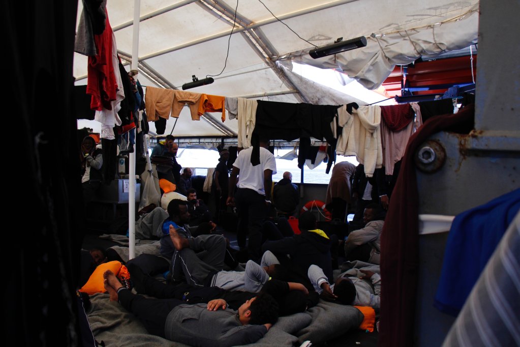 Rescued passengers on the Humanity 1 with their clothes hanging up to dry. | Photo credit: Nicole Thyssen / SOS Humanity