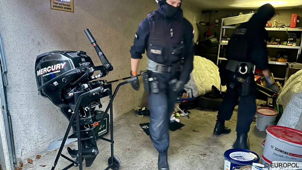 German police officers search premises near Essen and find, among other things, an outboard motor that could be used for a small boat crossing | Photo: Europol press office