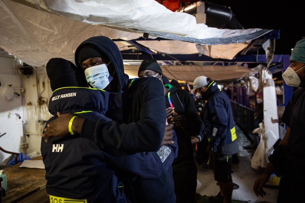 Migrants hug rescuers as they are told they can disembark in November 2022 | Photo: SOS Humanity