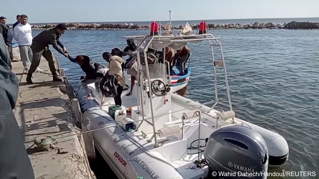 A Tunisian national coast guard helps migrants off a rescue boat in Jbeniana, Sfax, Tunisia April 23, 2022, in this screengrab from a video | Photo: Wahid Dahech/ Handout via REUTERS