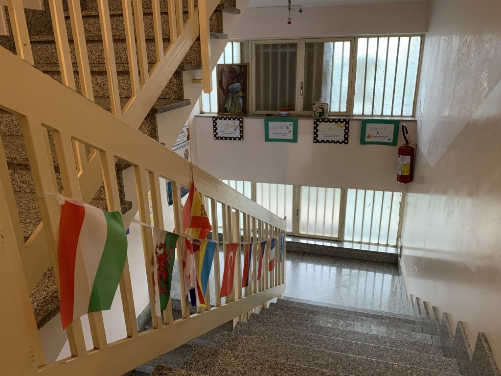 Flags line the staircases at the SAI center in Caltagirone | Photo: Emma Wallis / InfoMigrants