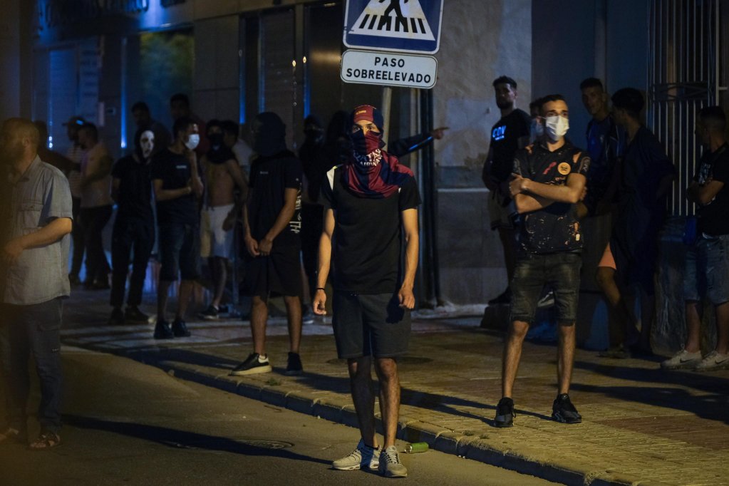 Masked people gathered at the San Antonio district in the town of Torre Pacheco, Murcia, southeastern Spain, late 14 July 2025 | Photo: EPA/PABLO MIRANZO
