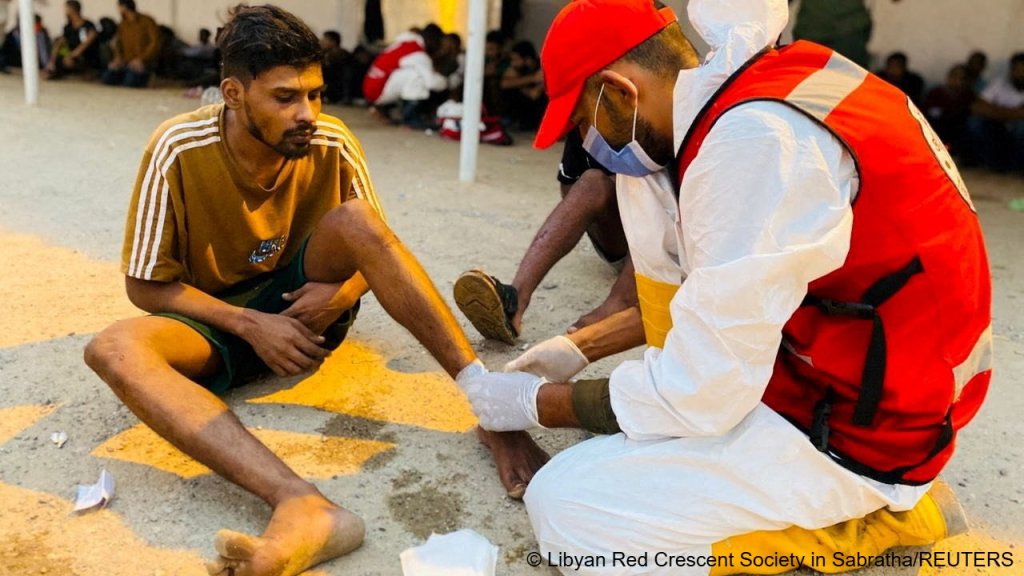 A member of the Red Crescent provides medical aid to a man who survived after a boat capsized off the coast of Libya | Photo: Libyan Red Crescent Society in Sabratha / Reuters