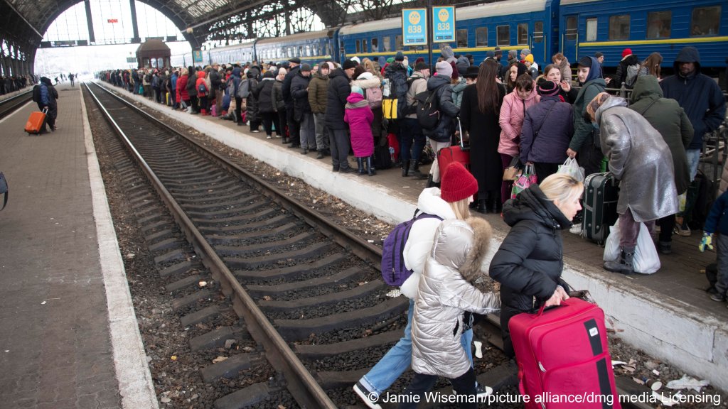 Hundreds of women and children at the main railway station of the western Ukrainian city of Lviv try to catch trains to Poland to escape fighting on February 27, 2022.