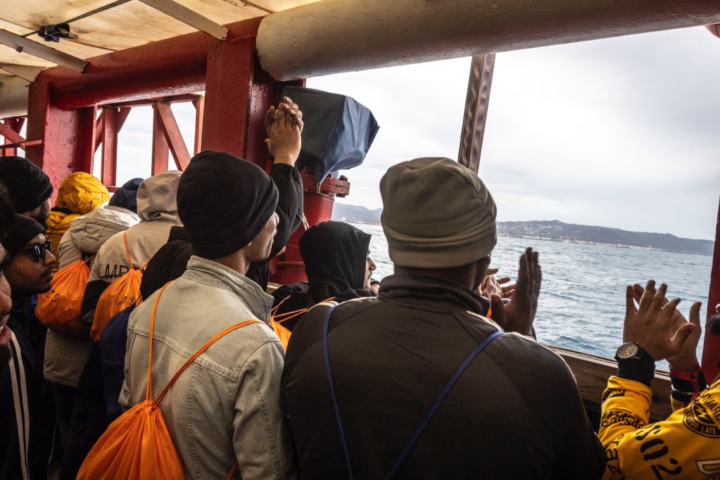 Those on board the Ocean Viking, operated by SOS Mediterranee clap as they near the port of Livorno where they were able to disembark on April 10 | Source: X feed @SOSMedIntl
