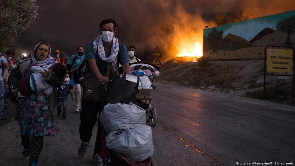 Migrants and refugees fleeing Moria camp after a fire broke out 