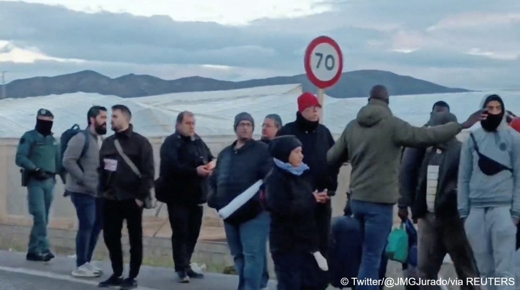 People wait in line following a fire at El Walili migrant camp, in Almeria, Spain, January 30, 2023 in this image obtained from social media. Twitter/@JMGJurado/via REUTERS