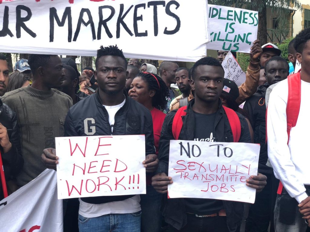At a protest in the capital Nicosia, asylum-seekers hold up banners asking for work and protesting about their exploitation. Some claim to be offered money and help in exchange for sex. April 16 2019 | Photo: Caritas Cyprus