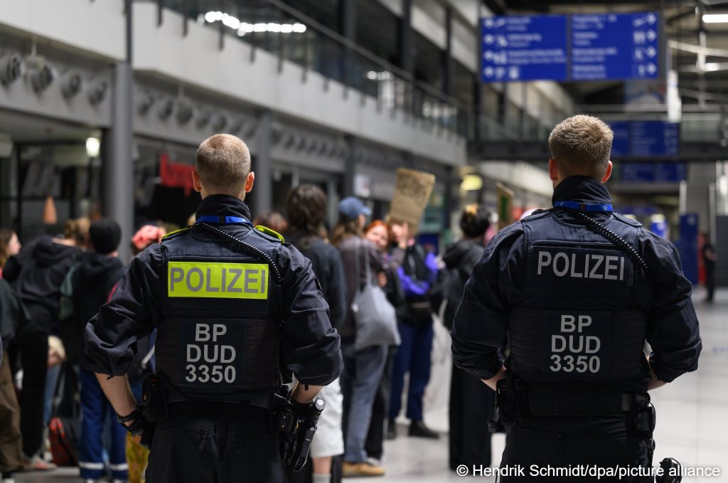 Participants in a vigil are standing in the terminal at Leipzig/Halle Airport, holding up a sign that reads "Afghanistan not safe" on June 15, 2026. They are protesting an alleged deportation flight to Afghanistan | Photo: Hendrik Schmidt/picture-alliance