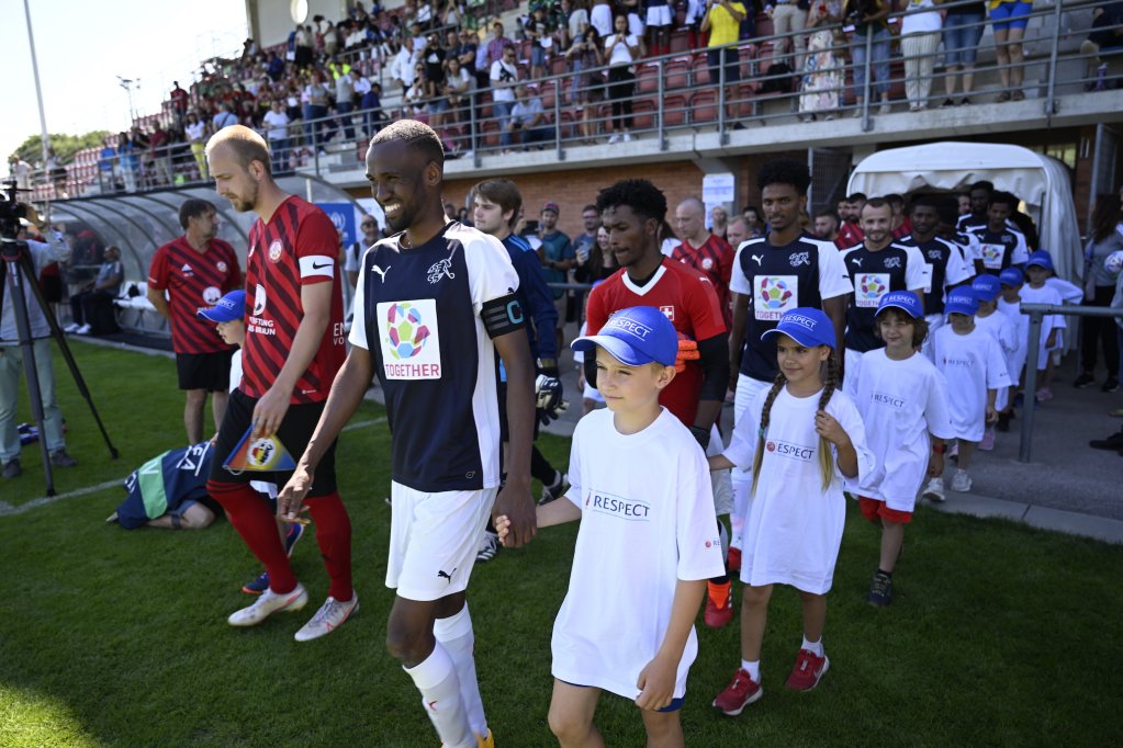 The amateur athletes were accompanied by children as they entered the stadium in Nyon | Photo: UEFA