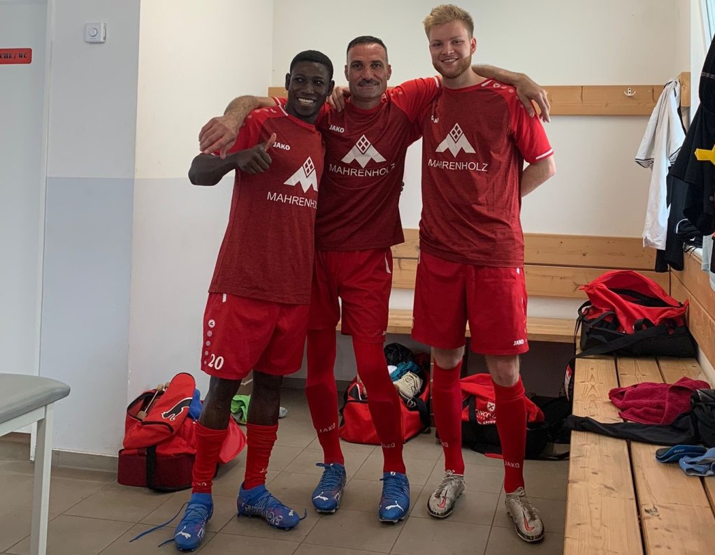 Dheyab Ali (middle) after a match of his soccer club in Bad Saarow with two other players of in the locker room | Credit: FSV Preußen Bad Saarow