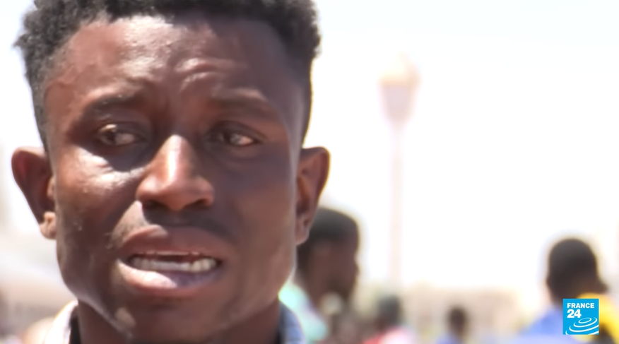 Mohamed Mansari, a migrant from Sierra Leone is pictured visibly upset before boarding a train for Tunis because he feels his life is in danger in Sfax | Source: Screenshot of France 24 TV report