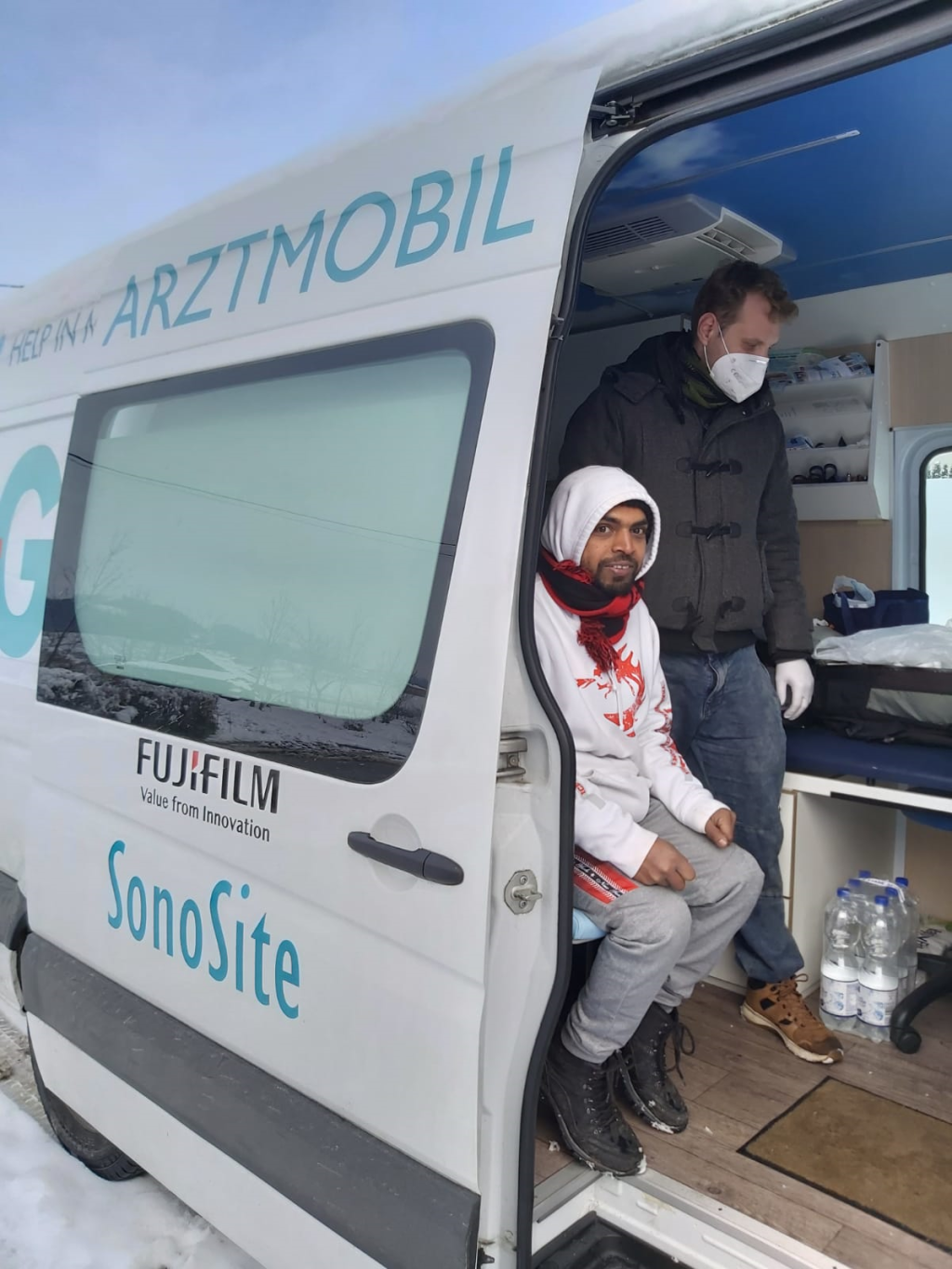 A migrant and a member of the "Armut und Gesundheit in Deutschland" team inside one of the organization's mobile practices in Bosnia | Photo: Gerhard Trabert