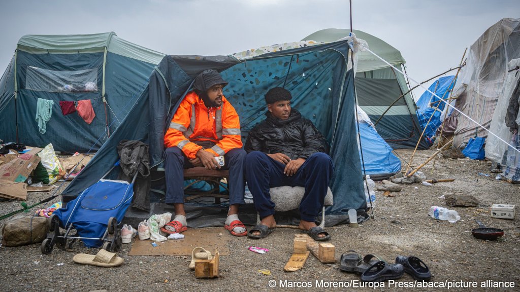 Migrants sitting in a tent on a beach in Ceuta on October 5, 2026, as police try to evacuate camps in the Spanish city | Photo: picture alliance
