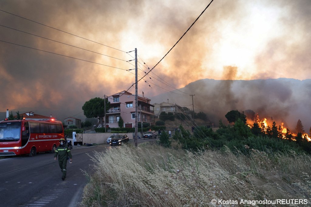 A fireman walks as wildfire, fanned by strong winds, approaches residential areas near the village of Karyes on the Greek island of Chios on June 22, 2025 | Photo: Kostas Anagnostou/Reuters